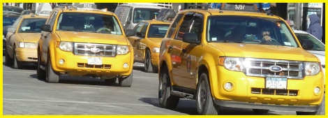 Taxi cabs traveling down New York’s Fifth Avenue.