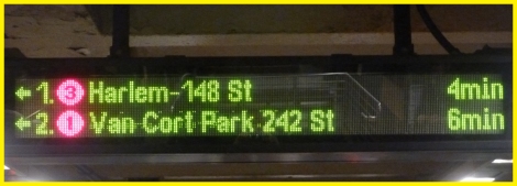 Sign alerting passengers of train status on a NYC Subway Platform.